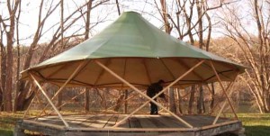 Installation of Ultra-Yome yurt home nearing completion on a wooded lot